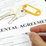 Close up of hand singing rental agreement