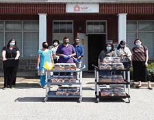 SHIP team posing with community donations outside SHIP offices