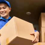 Delivery man holding a box and clipboard