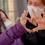 Woman and daughter wearing facemasks