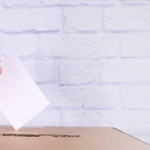 Hand placing ballot in ballot box